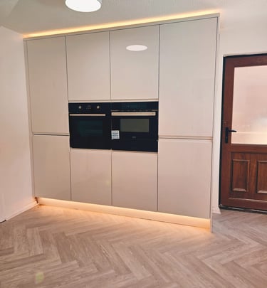 white kitchen with infit oven, with nice warm back lighting
