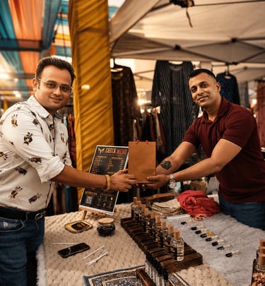 A smiling couple shopping at a vibrant night market with stalls and warm lighting.