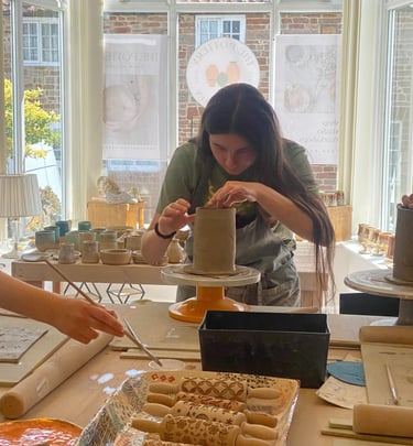 A young teenager making a slab built mug at a pottery class in Chew Magna