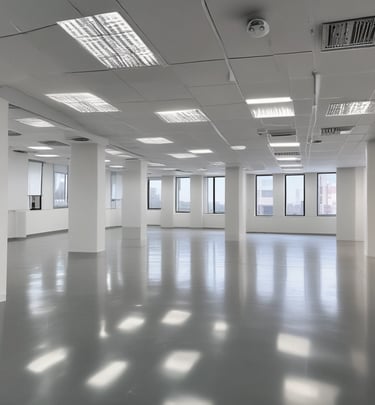 A worker is suspended on ropes, cleaning the windows of a large brick building. The person is equipped with cleaning gear, including a brush and a safety harness attached to a bucket of supplies. The window panes have visible streaks being cleaned, contrasted against the industrial background of brick and metal.