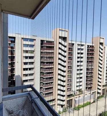 a balcony invisible grill with a view of a city skyline
