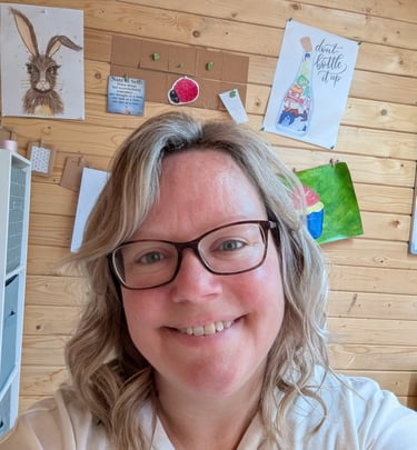 a woman with glasses and a white shirt