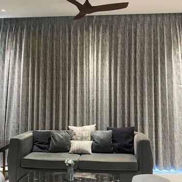 a living room with a couch and a ceiling fan