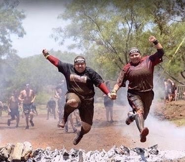 Female WOR battle buddies at Spartan racers at fire jump