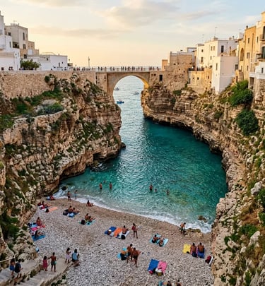 Lama Monachile cove beach framed by cliff walls and historic bridge in Polignano a Mare