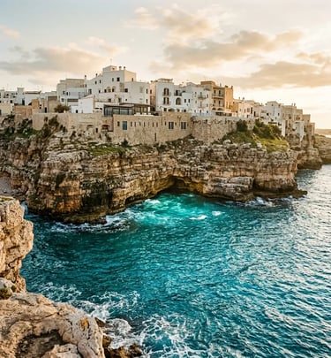 Polignano a Mare whitewashed buildings on limestone cliffs above Adriatic sea cave