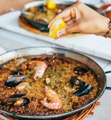 Fresh seafood paella with lemon served as part of 3-course meal in Tossa de Mar