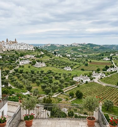 Panoramic view of Valle d Itria with olive groves vineyards and trulli from Locorotondo terrace