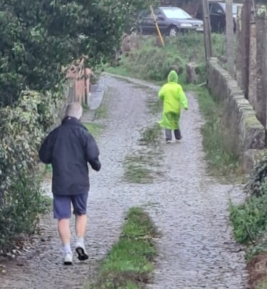 runners on a cobbled road in rain