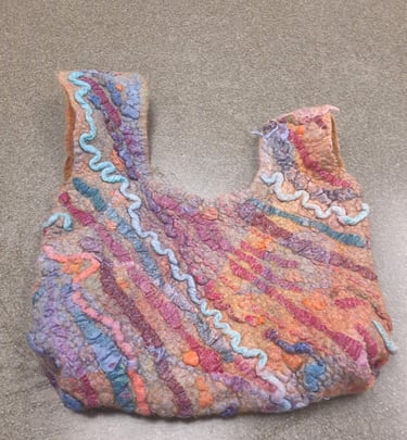 Handmade colorful felted wool tote bag with textured wavy patterns in purple, orange, and blue.