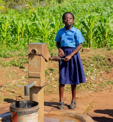 Girl standing at well