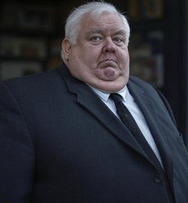 a man in a suit and tie is standing in front of a doorway