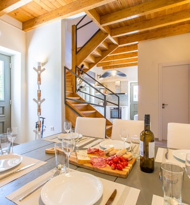 Dining table set with local Cretan wine and delicacies at Villa Skyphos