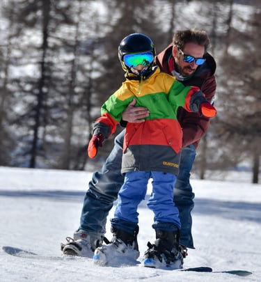 Bambino durante una lezione di snowboard a Sestriere con il maestro
