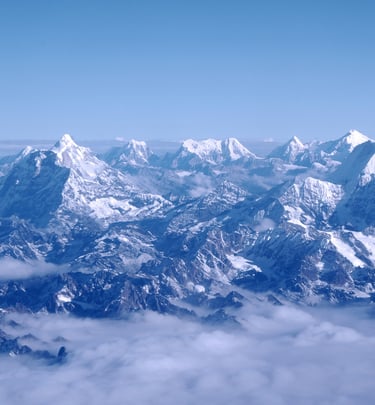 an aerial shot of the Himalayan mountain range on a clear day