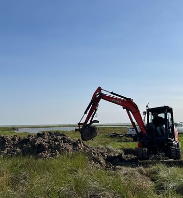 a construction digger working near the coastline