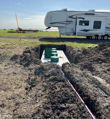 a RV parked beside a newly installed septic system