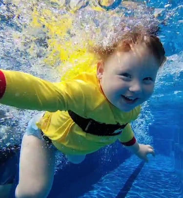 a toddler learning to swim