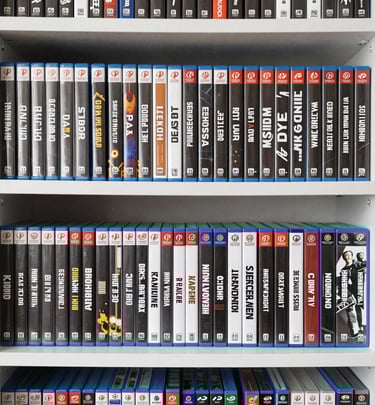 Stack of newly released video game boxes arranged neatly on a wooden table