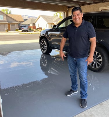 Benjamin and a satisfied client smiling together outside a freshly renovated home in Littleton, Colorado.