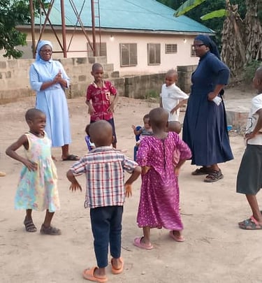 Catholic nuns play outdoor games with children at a community center in Africa.