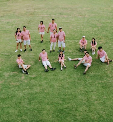 Extended family group portrait on the lawn at Alila Seminyak Bali, candid luxury family photography session.