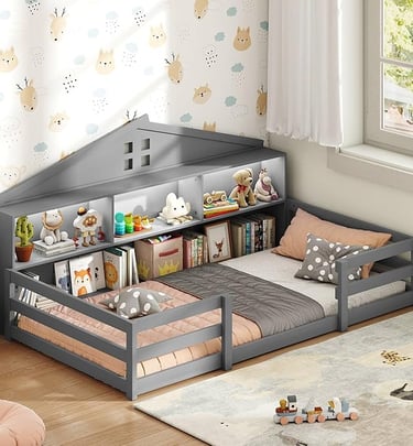 Gray wooden house-shaped floor bed for kids featuring built-in bookshelves and storage headboard.