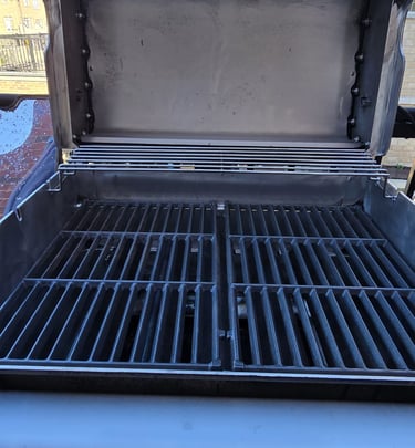 Close-up of professionally cleaned BBQ grill grates showing spotless finish