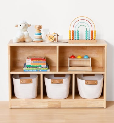 a wooden shelf with baskets and toys