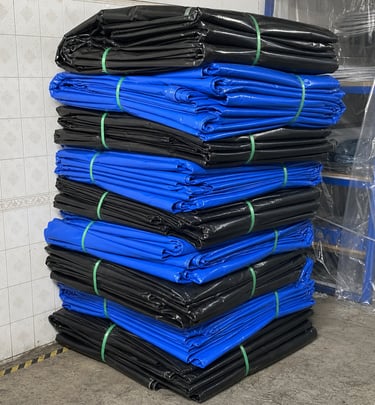 PVC Tarpaulin Sheets are stacked in the warehouse