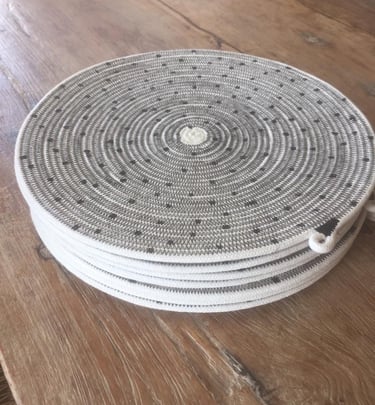 a round wicker basket weave basket with a white and black basket