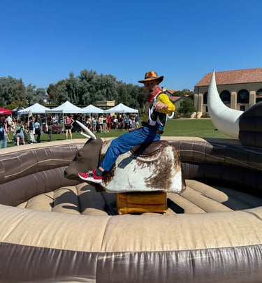 Alex Accetta on a bucking bull when dressed as Woodie from Toy Story
