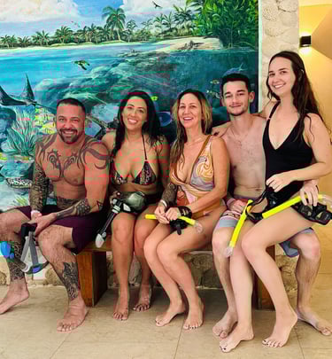 a group of people sitting on a bench in front of a mural of a painting