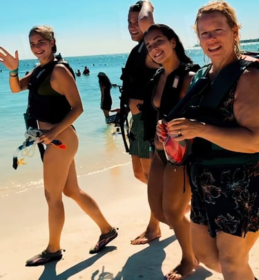 a group of people standing on a beach