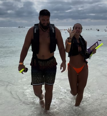 a man and woman walking in the water