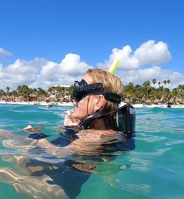 a woman in a diving suit is shown in the water