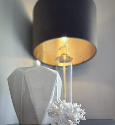 Black lamp with a gold interior and glass stem, illuminated, with decorative ornaments
