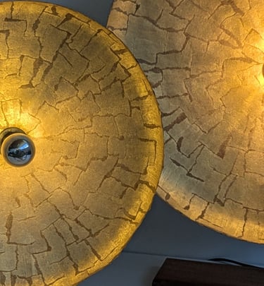 two large gold colored lamps with a gold colored lamp