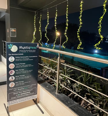 A clear sign positioned on a building's balcony, visible to those walking by, conveying important information