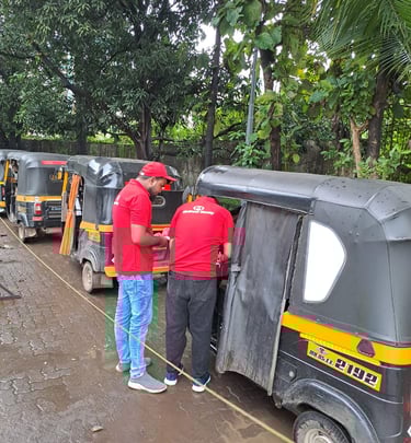 a man and a woman are standing in front of a line of tuk tu