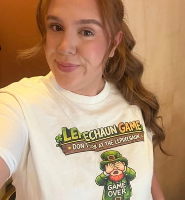Woman wearing a St. Patrick's Day Leprechaun Game graphic tee shirt with shamrocks.