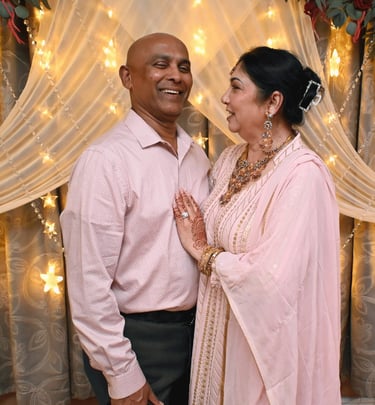 a man and woman standing in front of a curtain