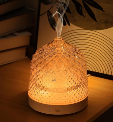 a small glass diffuser with smoke coming out of it