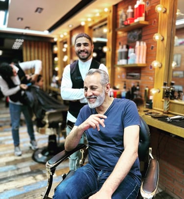 a man sitting in a chair in a barber shop