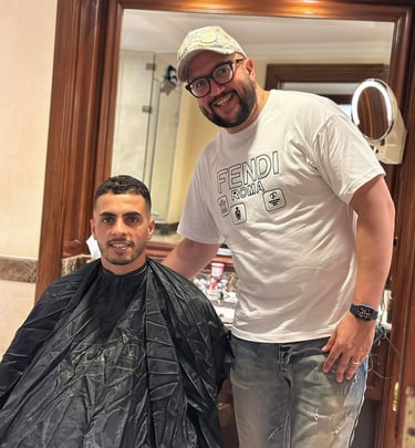 a man is getting his hair cut by a barber