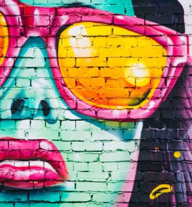 Graffiti brick wall with painting of girl with sunshades