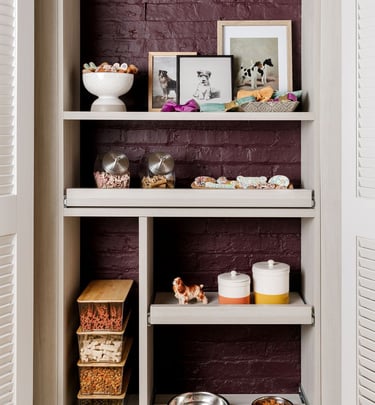 a kitchen with a brick wall and shelves with bowls of food