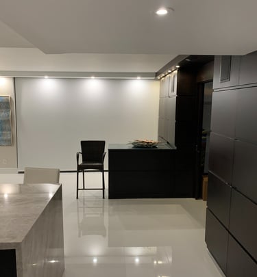 a kitchen with a large counter top and a bar stool