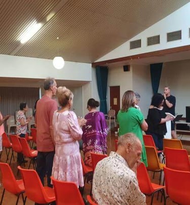 Church members standing and worshipping together during a service.