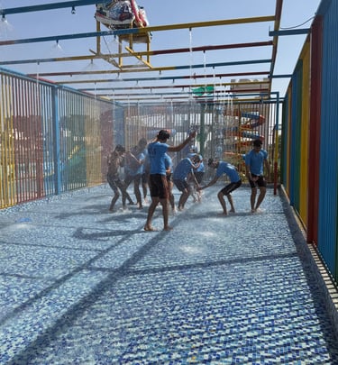 a group of people playing with water in a playground